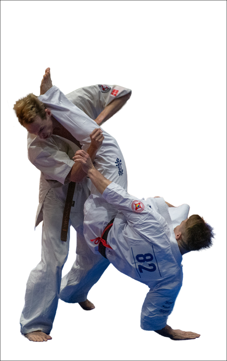 Two men in white judo gi perform a throw, one lifting the other mid-movement in a match.